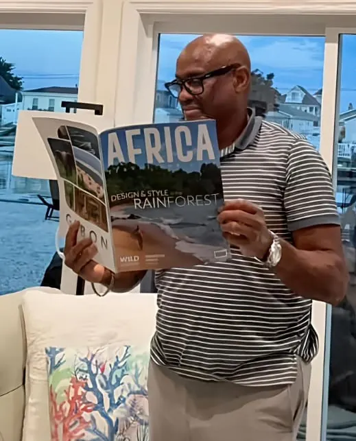 A reader holding the Rainforest issue open at full size